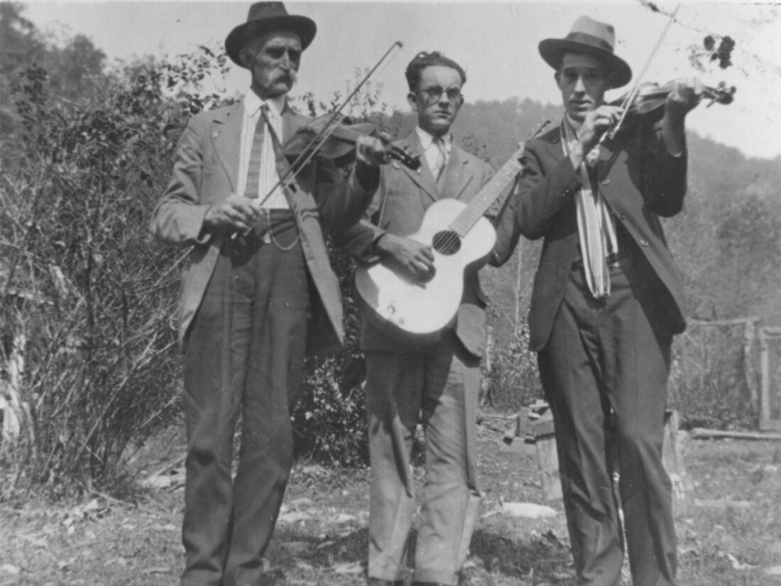 A group of musicians stand outside
