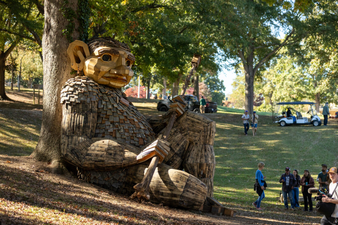 A large troll sculpture in a park