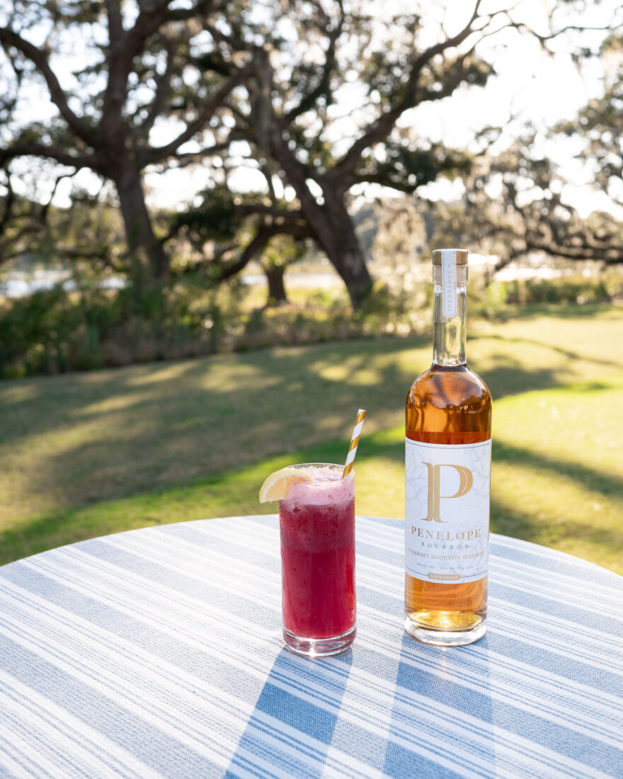 The Maker Marché signature cocktail featuring Penelope Four Grain, blackberry syrup, and lemonade.