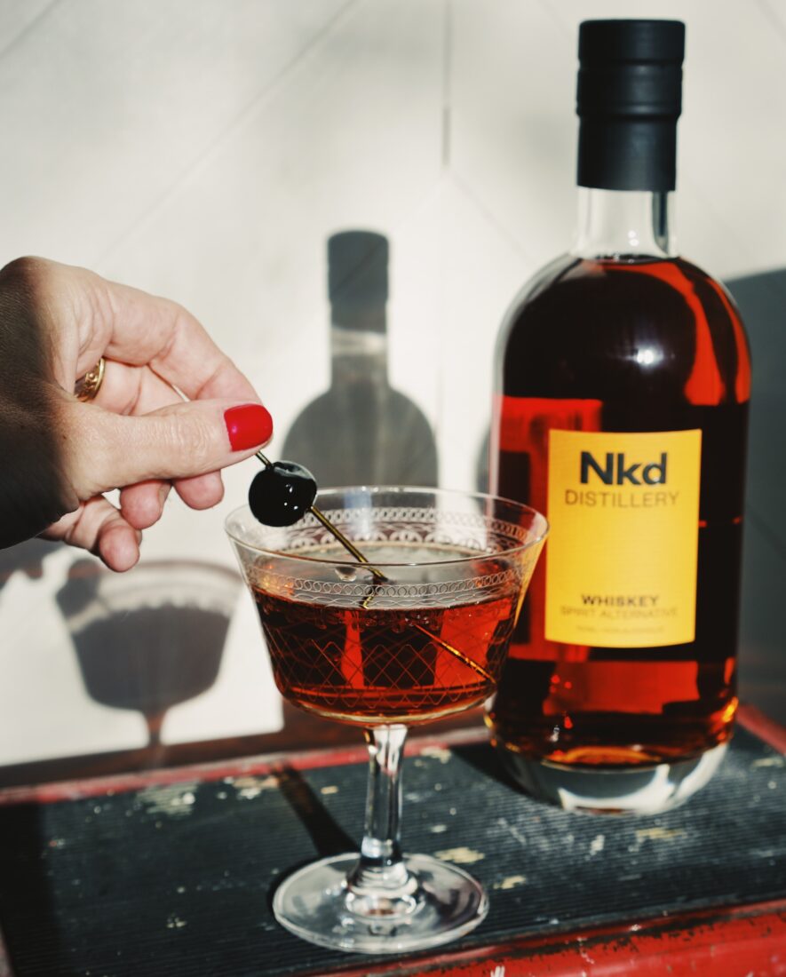 Nkd Distillery cocktail and bottle