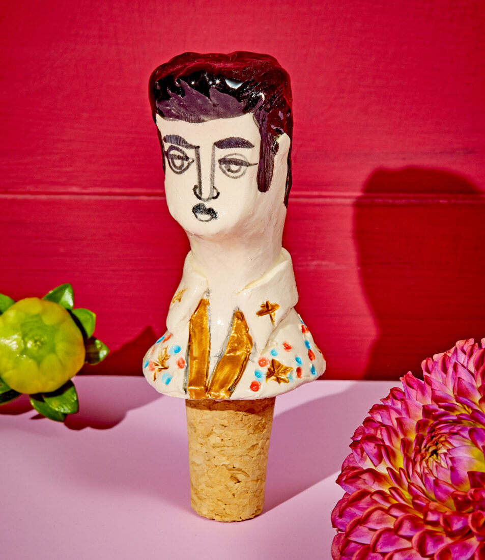 A ceramic elvis head on a wine stopper
