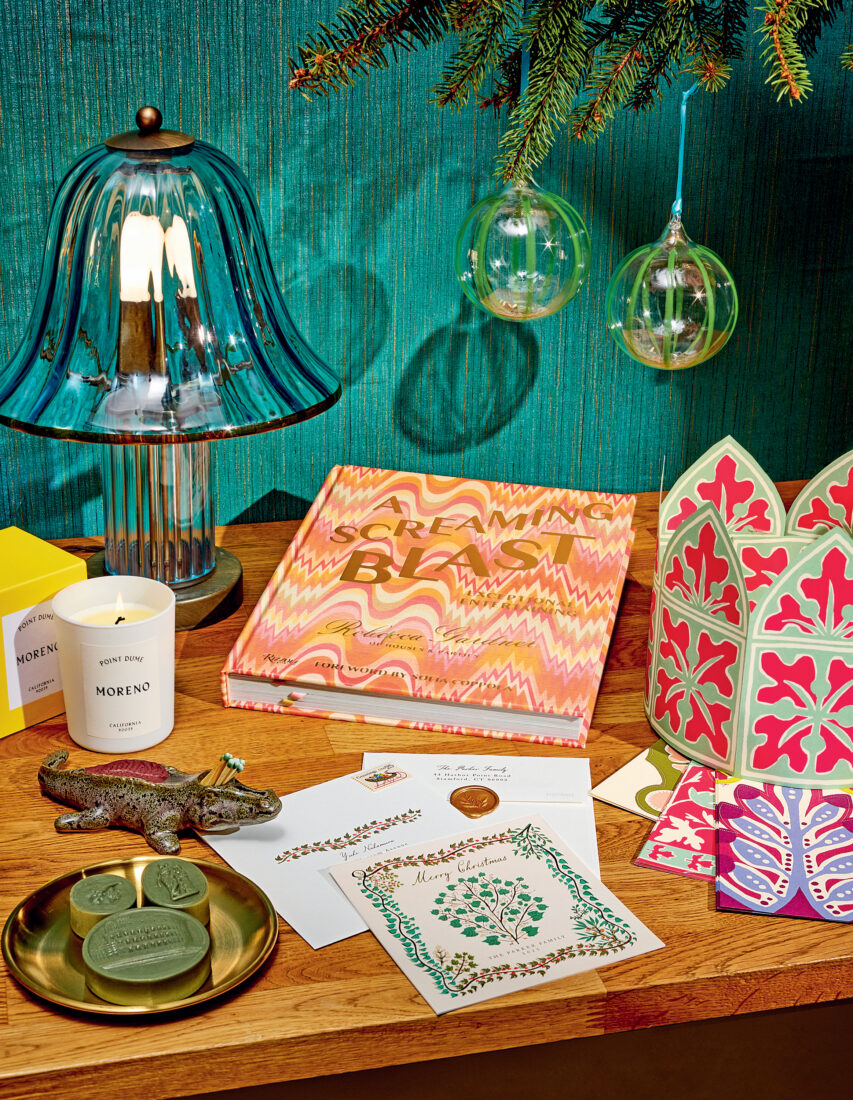 A spread of holiday cards, crowns, and a book