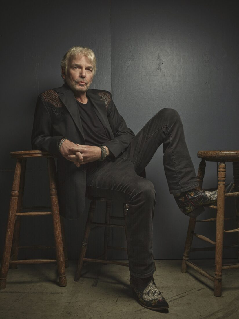 A portrait of Billy Bib Thornton in a stool