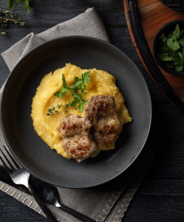 A plate with grits and quail