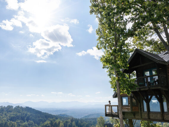 A bride on a deck overlooking a mountain scene