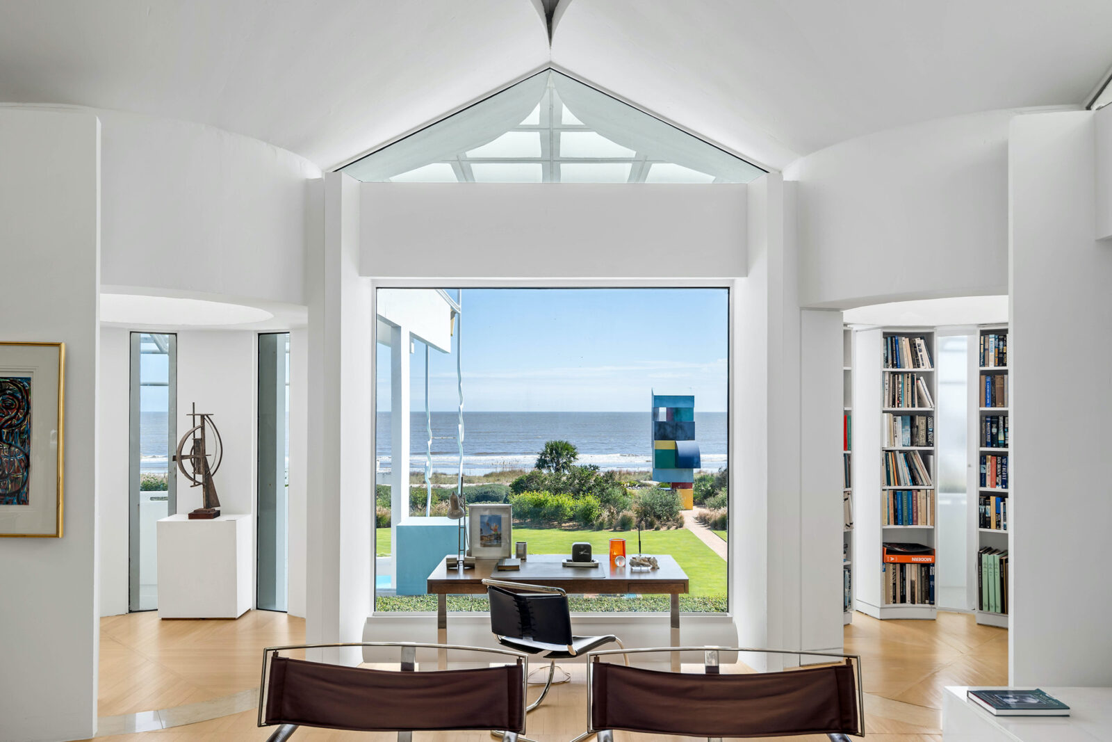 A white library with a view of the ocean