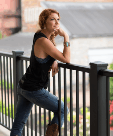 A portrait of a woman against a railing
