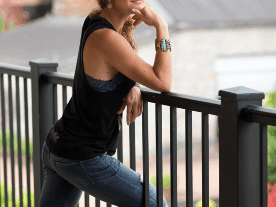 A portrait of a woman against a railing