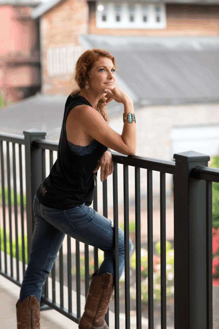 A portrait of a woman against a railing