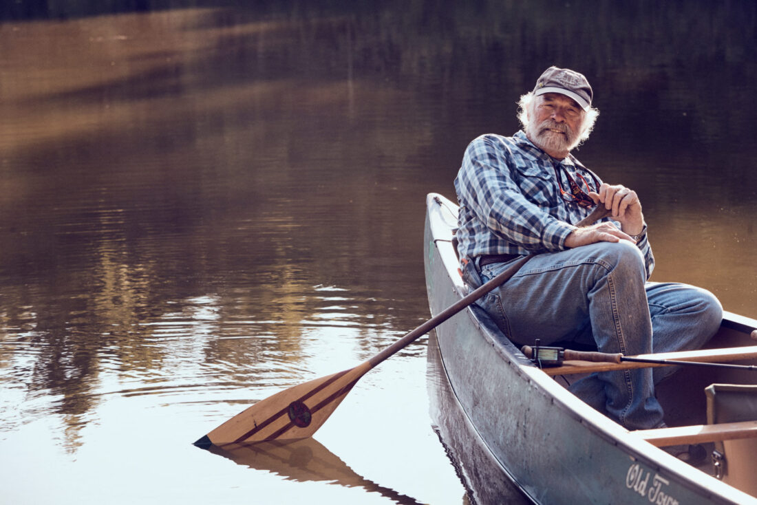 A portrait of a man in a canoe