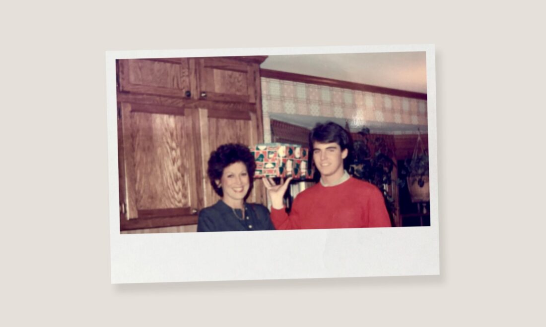 A vintage photo of a boy and his mother with a christmas present