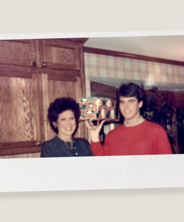 A vintage photo of a boy and his mother with a christmas present