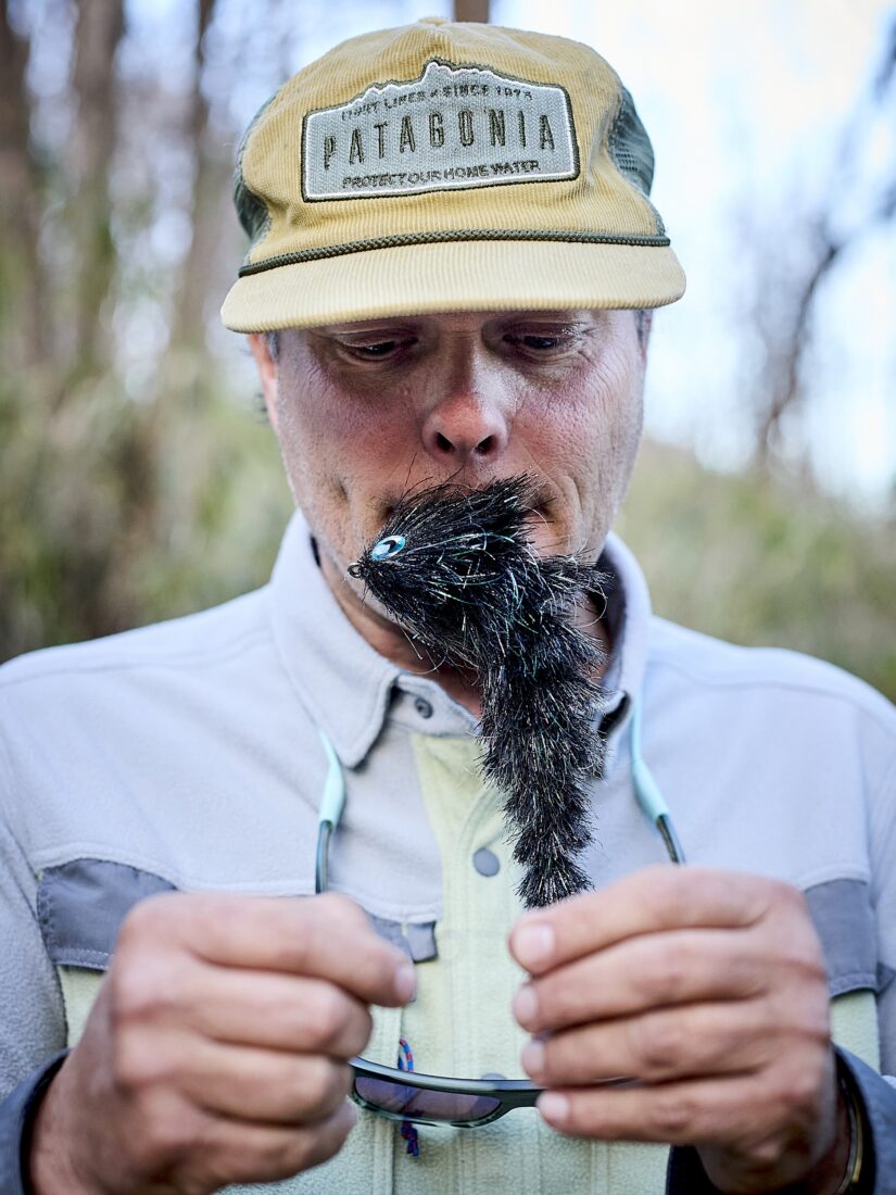 Blane Chocklett holds a fly in his mouth
