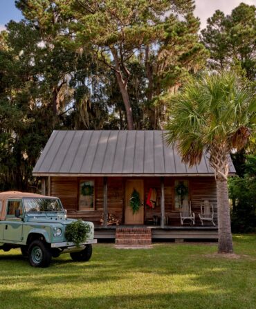 a Land Rover in front of a cabin