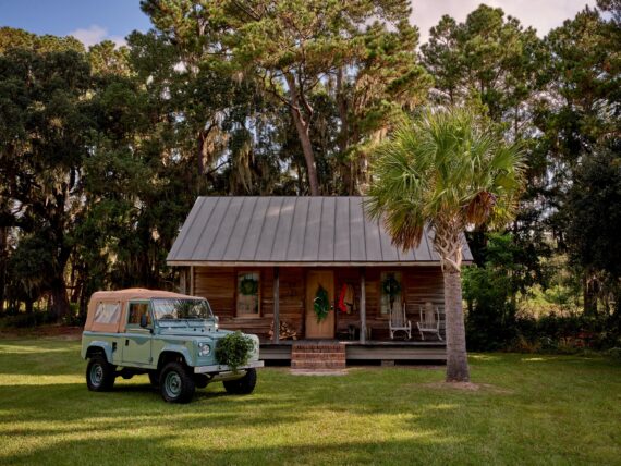 a Land Rover in front of a cabin