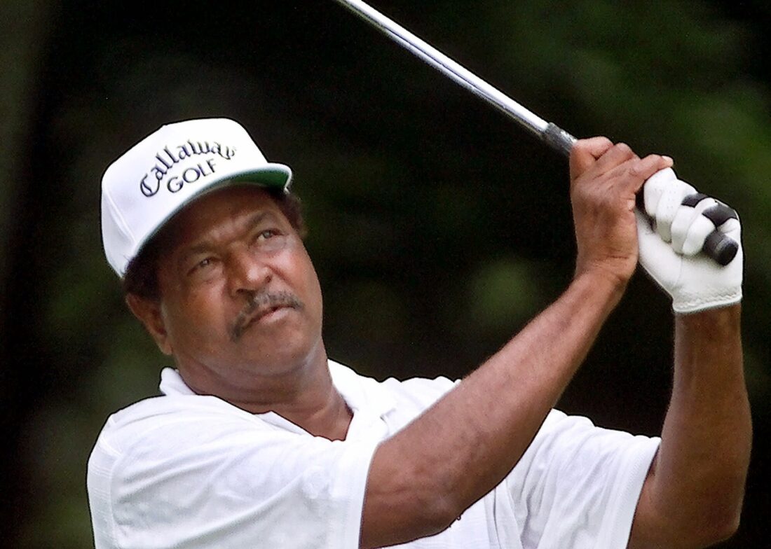 A portrait of a man playing golf