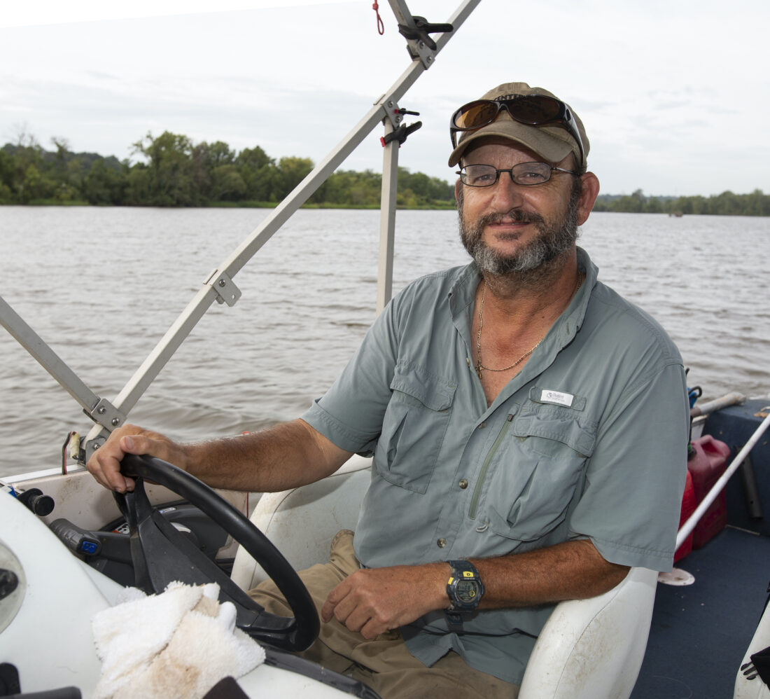 A portrait of a man driving a boat