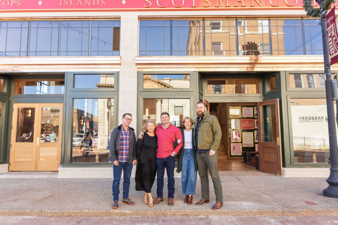 People stand in front of a historic building