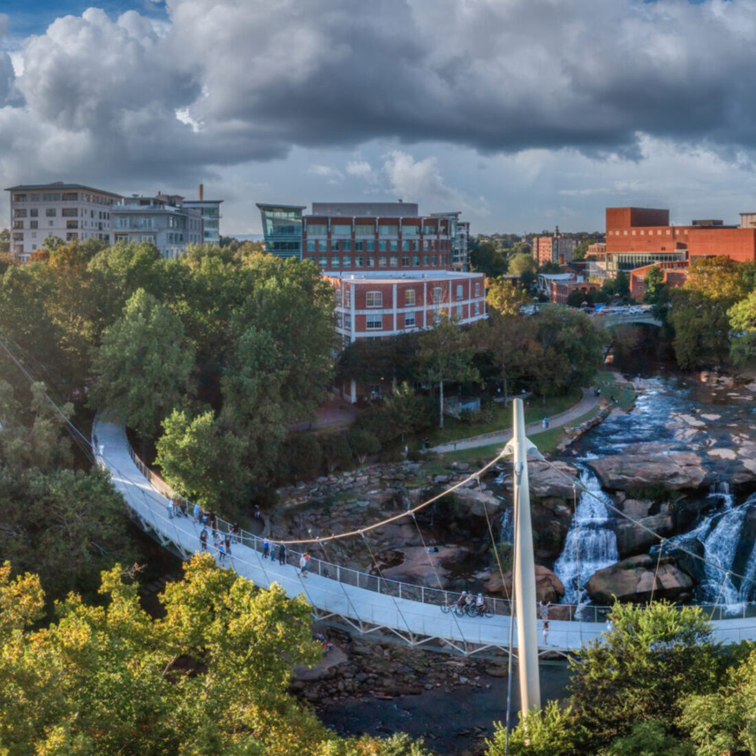 A view of a creek and downtown Greenville