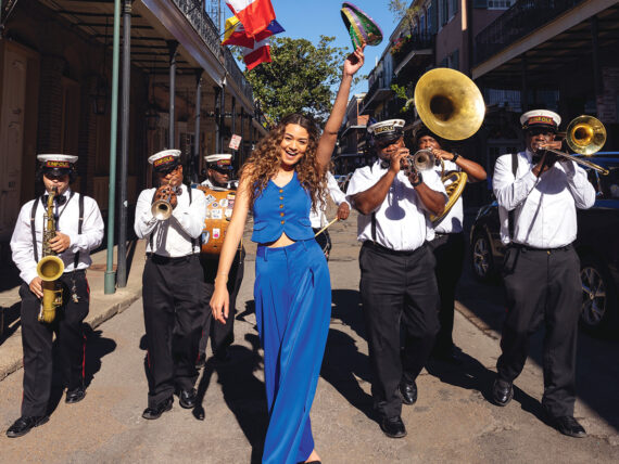 A woman at the front of a brass band