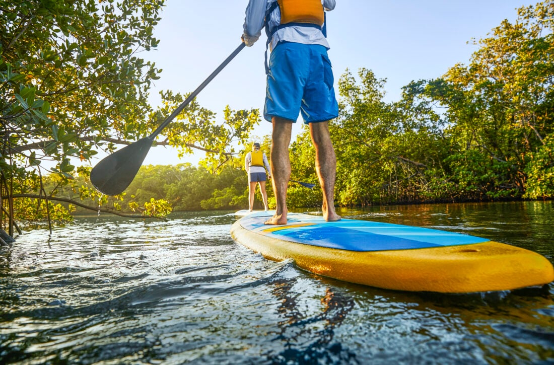 People paddle on the water