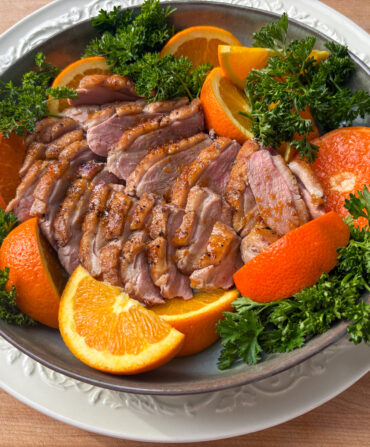 Roast duck and oranges in a bowl