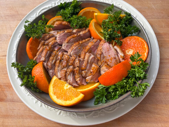 Roast duck and oranges in a bowl