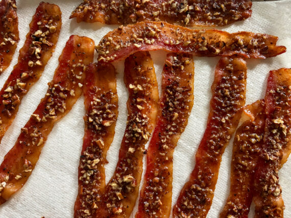 Bacon candied with brown sugar-bacon syrup, black pepper, and chopped pecans