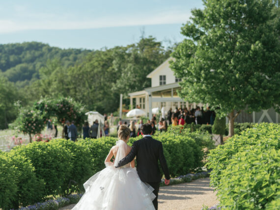 Newlyweds walk down a pathway