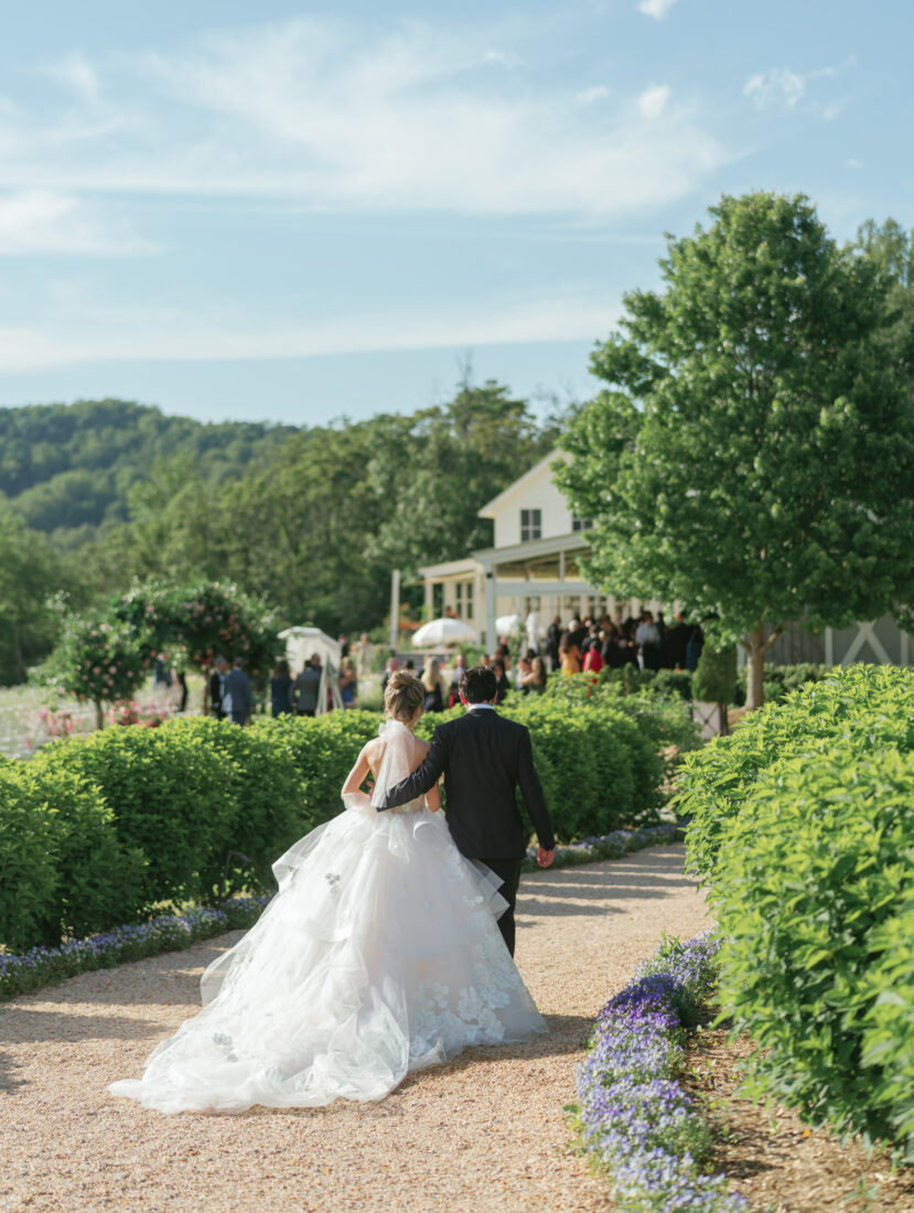 Newlyweds walk down a pathway