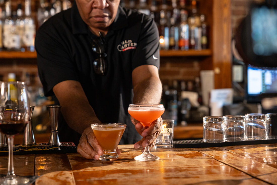 Two cocktails on a bar