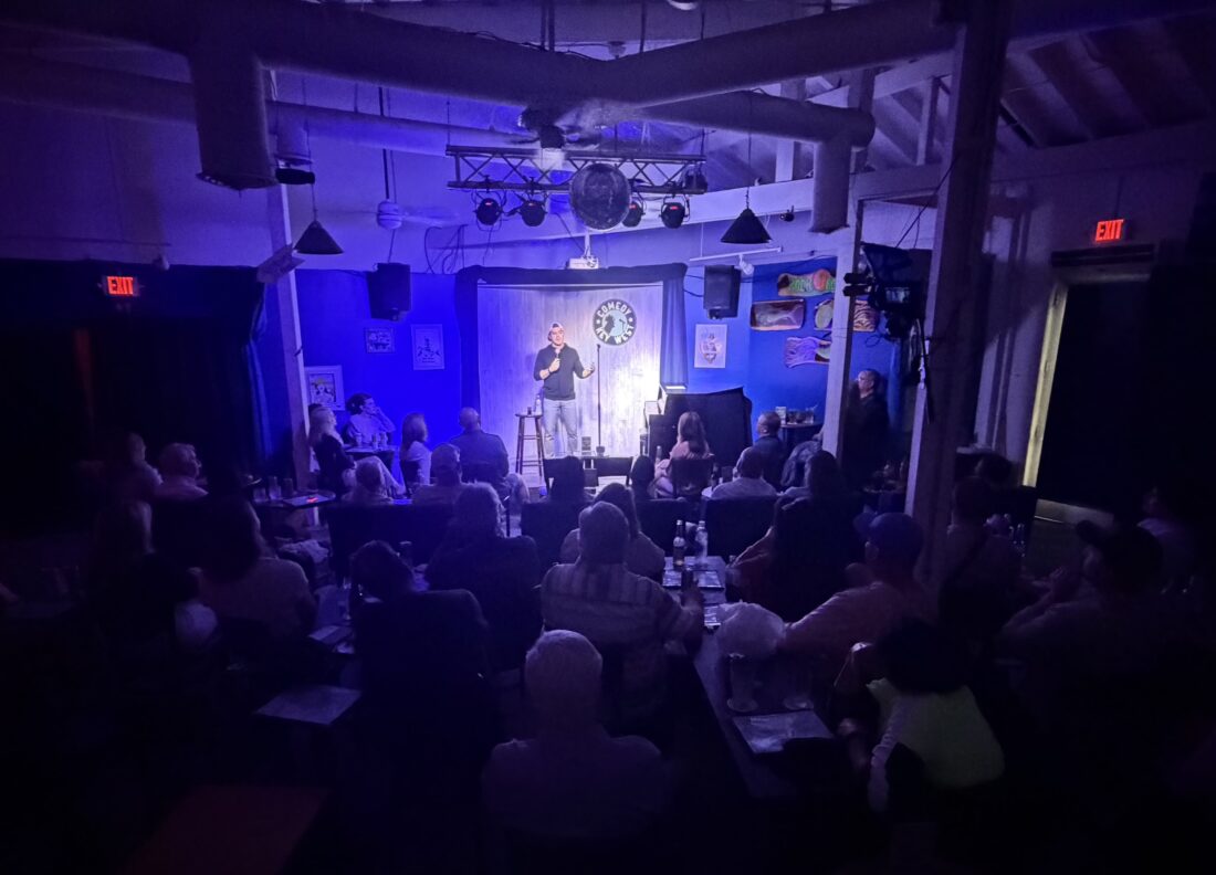 A man on stage during a comedy show