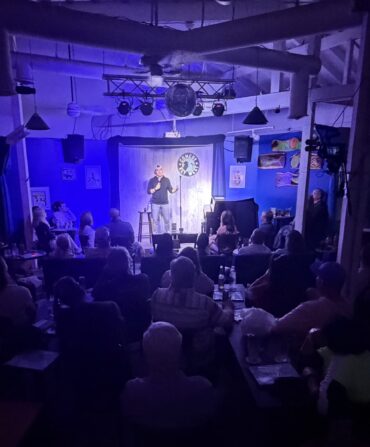 A man on stage during a comedy show