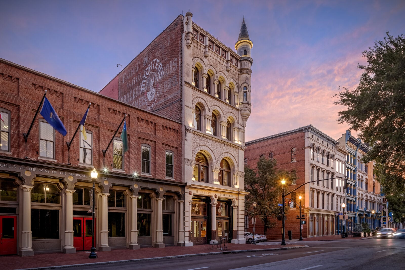 A street downtown with a brick distillery