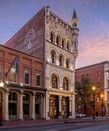 A street downtown with a brick distillery