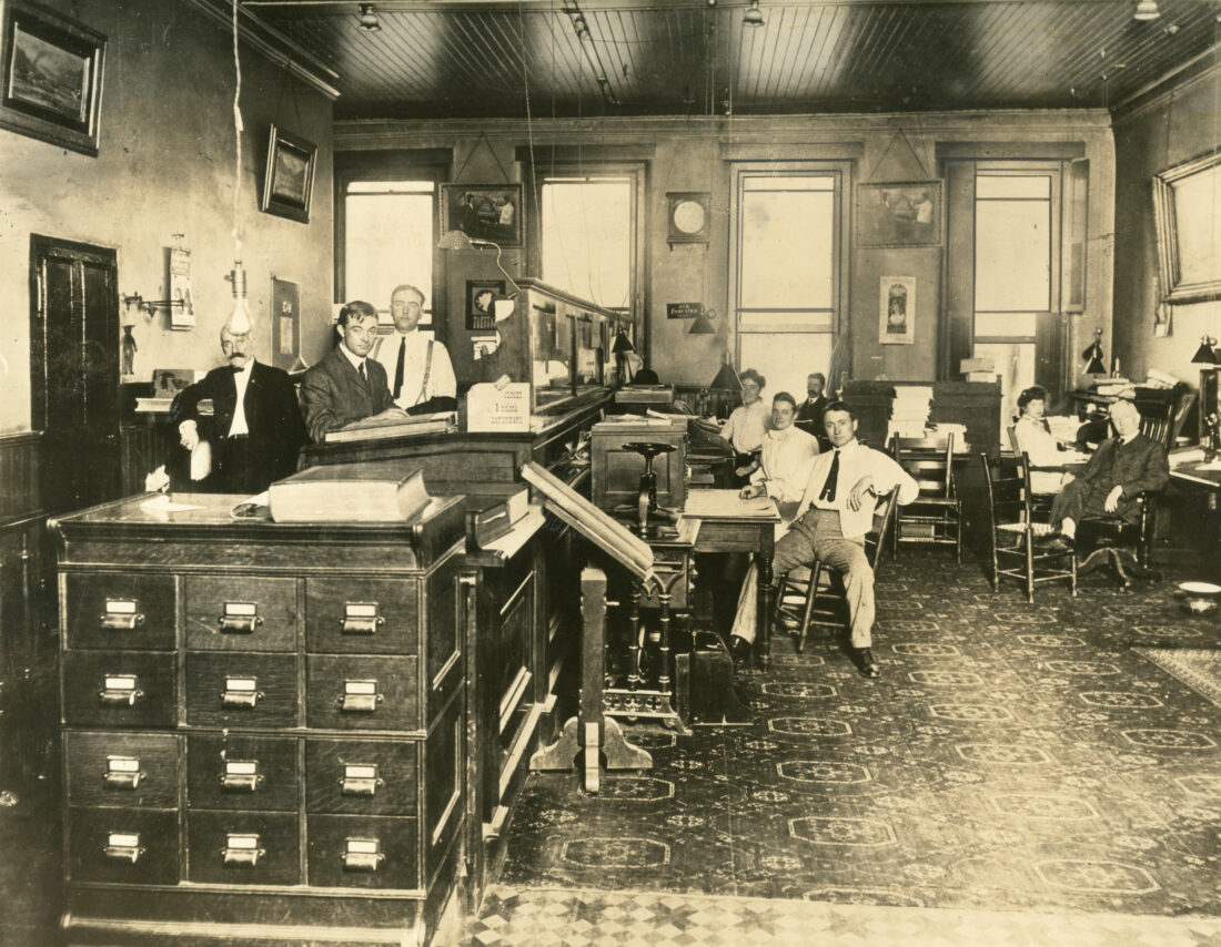 An old photo of an office of men