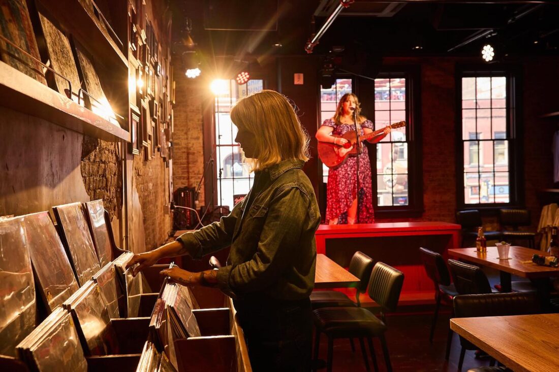 A woman goes through records at a record shop