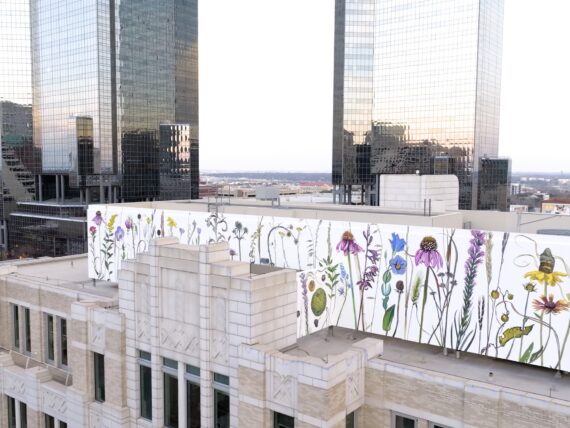 A wildflower mural on top of a city building