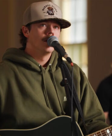 Dylan Marlow signing at a microphone