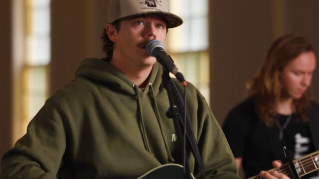 Dylan Marlow signing at a microphone