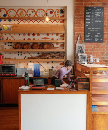 A woman behind a bakery counter