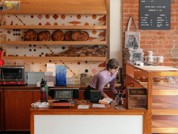 A woman behind a bakery counter