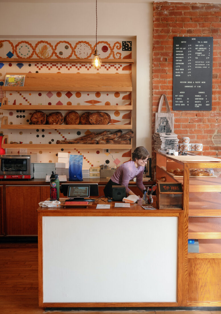 A woman behind a bakery counter