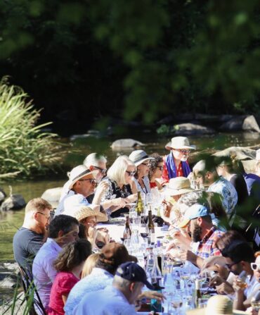 A dining table with people in a river