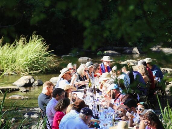 A dining table with people in a river