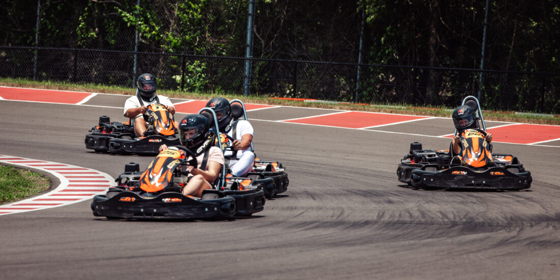 image of three go karts racing on an outdoor track