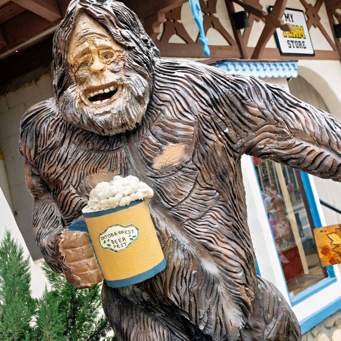 A bigfoot statue with a beer