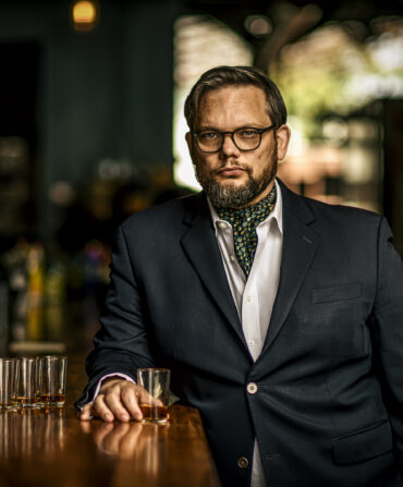 A portrait of a man with bourbon