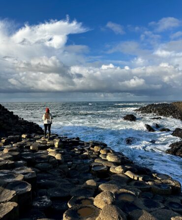 A woman on a rocky shore