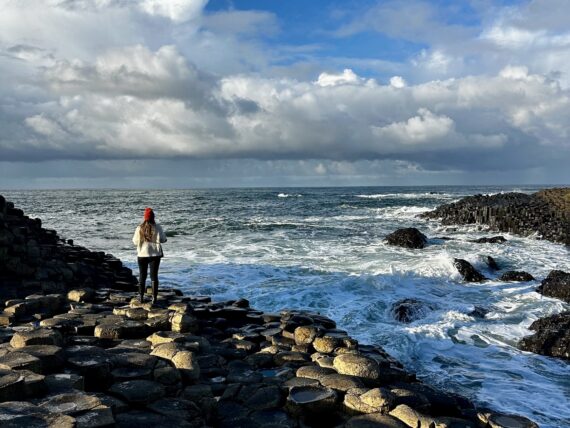 A woman on a rocky shore